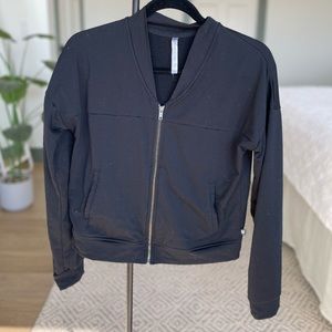 Black athletic zip up sweater.